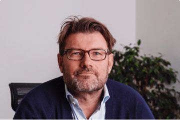 Codeable CEO Per Esbensen sitting on his work desk