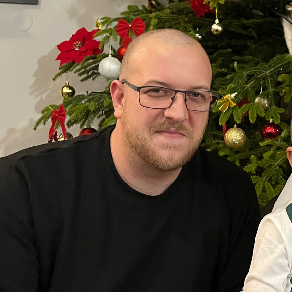 Photo of Codeable Expert Hunor Szőcs, slightly smiling posed in front of a Christmas tree