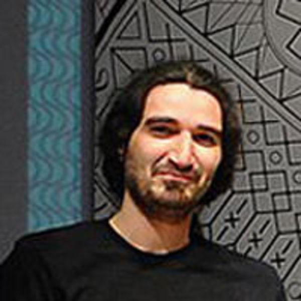 Photo of Codeable expert Spyros Vlachopoulos in front of a background with a variety of patterns